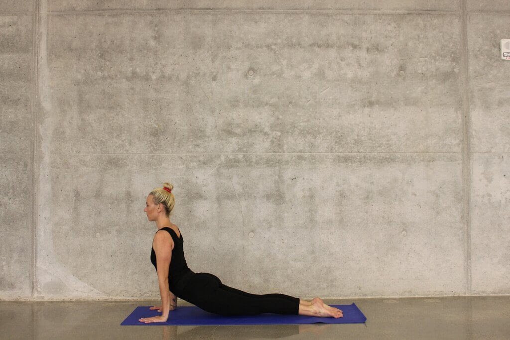 Image of woman practicing Yoga after doing the best Yoga course in Charkhi Dadri