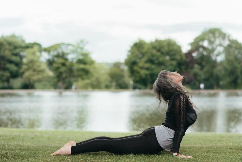 Image of woman practicing Bhujangasana after doing the best Yoga course in Rewari